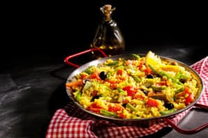 Colorful Vegetarian Spanish Paella Served with Oil