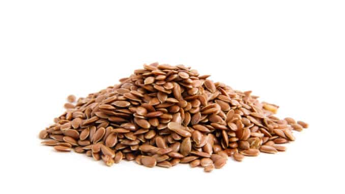 Flax seeds heap isolated on white