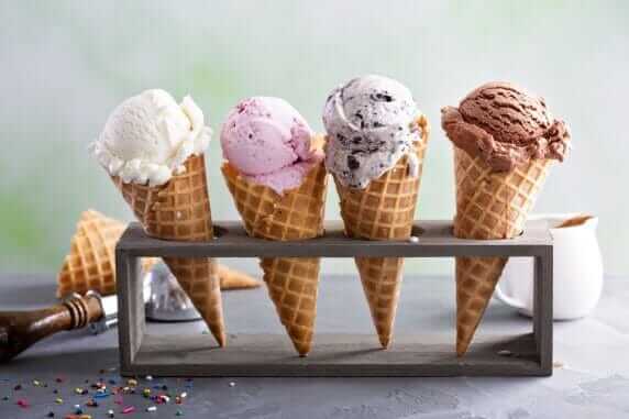 Variety of ice cream scoops in cones with chocolate, vanilla and strawberry Variety of ice cream scoops in cones with chocolate, vanilla and strawberry