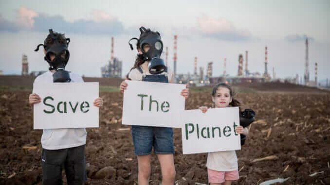 Save the planet. Young kids holding signs standing near a refinery with gas masks Save the planet. Young kids holding signs standing near a refinery with gas masks