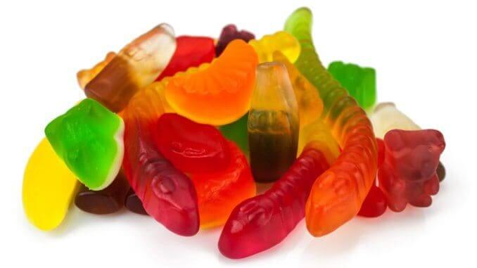 The colored fruit jelly sweets on white background The colored fruit jelly sweets on white background