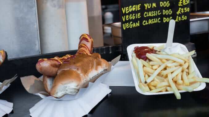 Vegan hot dog and french fries in Camden Town Market stand, London Vegan hot dog and french fries in Camden Town Market stand, London