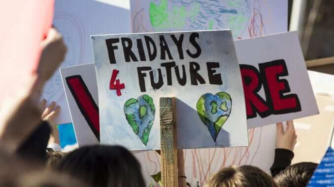 Protestors holding climate change banners at a protest Protestors holding climate change banners at a protest