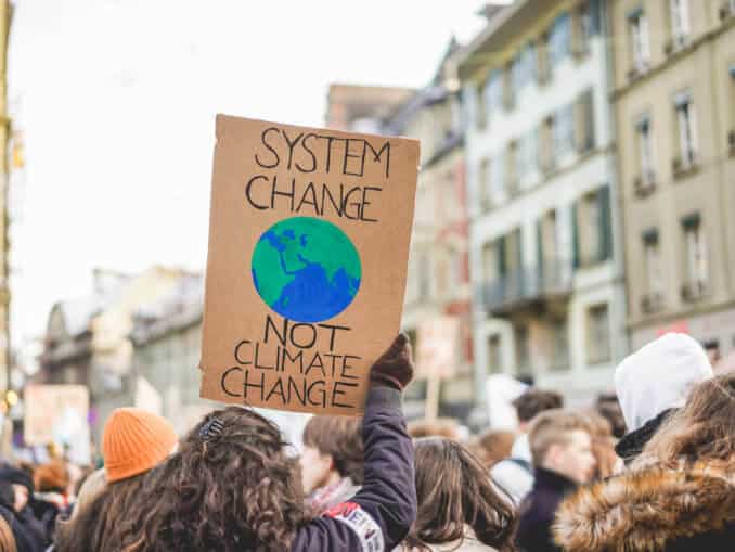 Group of demonstrators on road, young people fight for climate change - Global warming and enviroment concept - Focus on banner