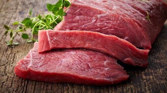 red raw meat on old wooden table red raw meat on old wooden table