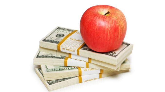 Red apple and dollar notes isolated on the white Red apple and dollar notes isolated on the white