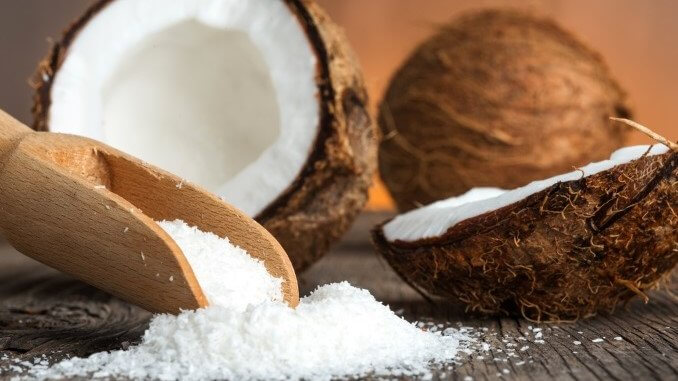 Close up of a coconut and grounded coconut flakes Close up of a coconut and grounded coconut flakes
