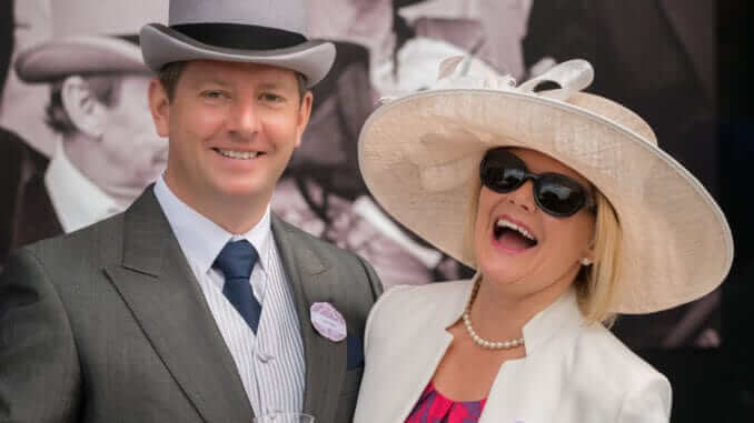 Couple at Royal Ascot laughing at camera Couple at Royal Ascot laughing at camera