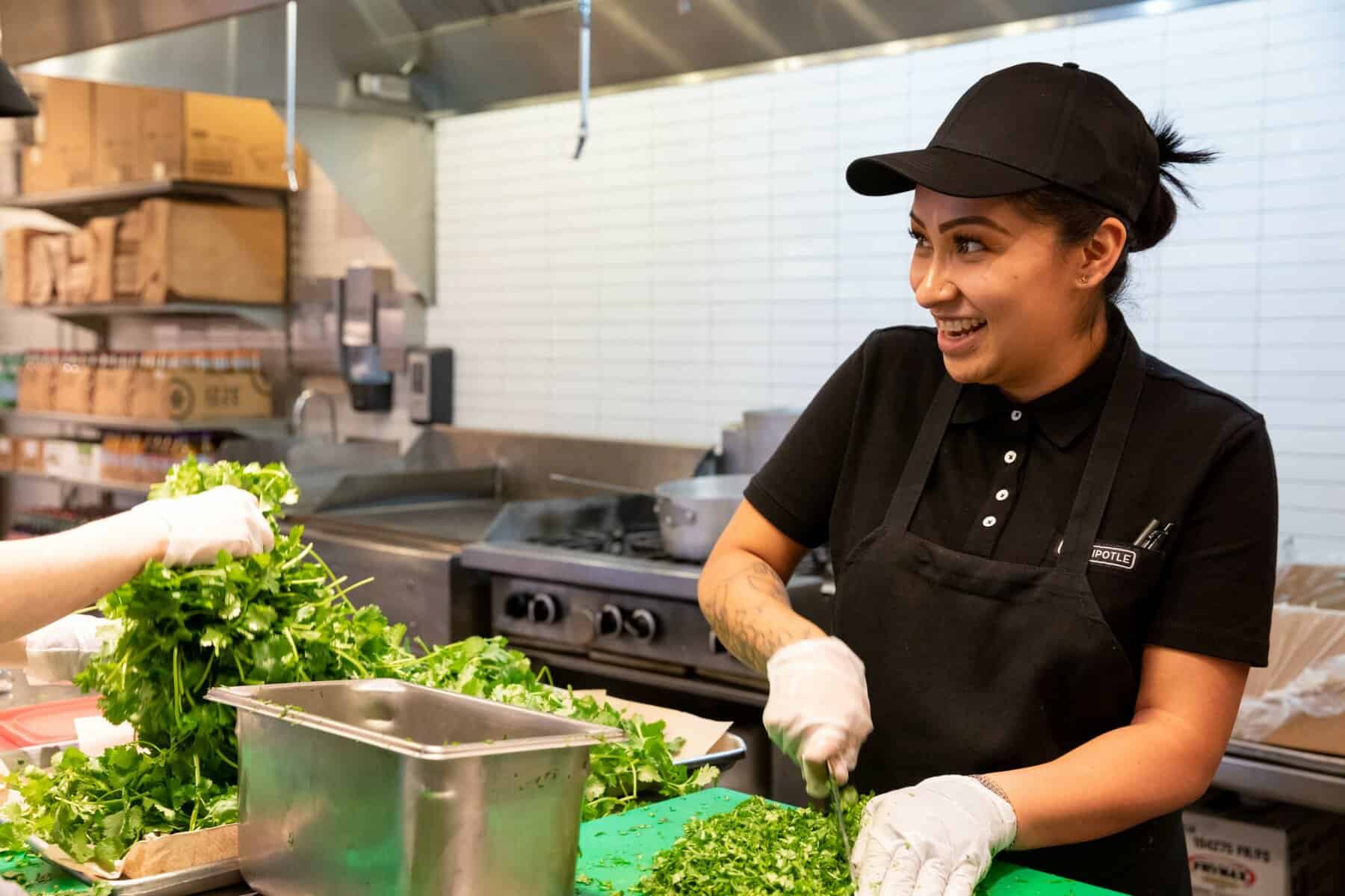 Cooks Preparing Greens in Restaurant