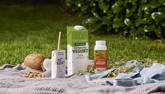 cp kelp and chr hansen plant-based milk and yogurt in a camping set surrounded by grass