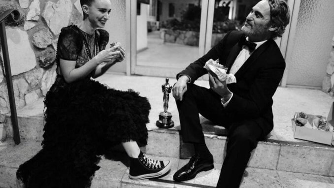 Joaquin Phoenix & Roony Mara with vegan burger