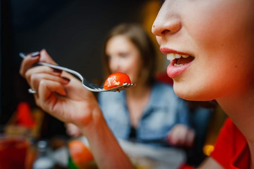 young woman eating salad